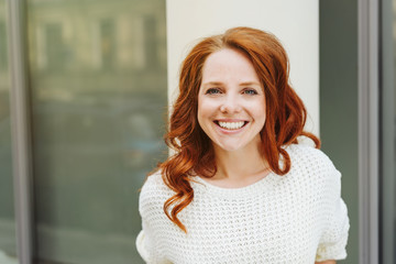 Happy friendly vivacious young redhead woman