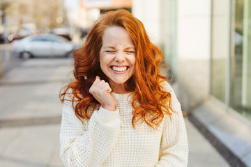 Excited ecstatic young woman cheering