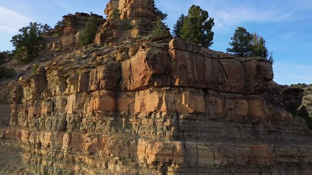 Viewing layers of dirt and rocks below the ground flying over cliff in the Utah desert in Nine Mile Canyon.