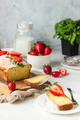 Pound or loaf cake with strawberry and mint on wooden board. Delicious summer dessert.
