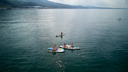 Aerial photography. The view from the top. A company of five young people in bathing suits doing...