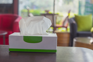 Tissue box on wooden table at home. Tissue paper for cleaning