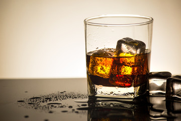 Beverage from cola in glass with ice in studio lighting,beverage in summer is sparkling water