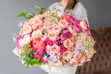 Large Beautiful bouquet of mixed flowers in woman hand. Floral shop concept . Beautiful fresh cut bouquet. Flowers delivery