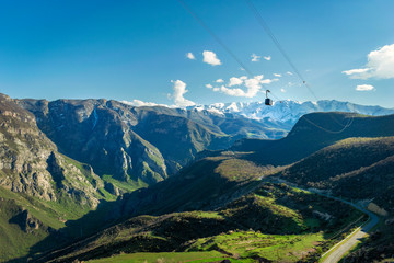 View from the top of tatev gorge while the famous longest cable car Wings of Tatev is passing above. South Armenian landscape