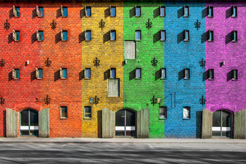 rainbow, LGBT flag. The facade of the house is painted in different colors.