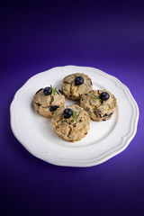 Fresh Baked Raspberry and Blueberry oatmeal wheat Scones set on Blue Background.