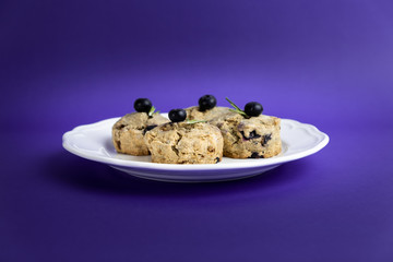 Fresh Baked Raspberry and Blueberry oatmeal wheat Scones set on Blue Background.