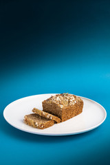 Almond bread loaf with Almond diced and Banana sliced set on Blue Background.
