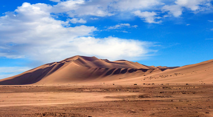 Golden sand dune 7 and white clouds on a sunny day