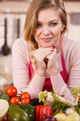 Woman having vegetables on table