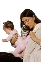 a young mother checks her baby's nappy
