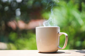Coffee cup glass on the wooden with smoke