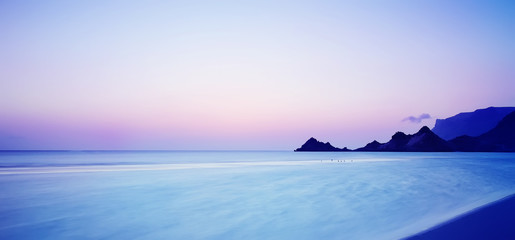 Naklejka na ściany i meble Sunset on a wild beach on the Indian Ocean on the paradise island beach.long exposure.Selective soft focus.