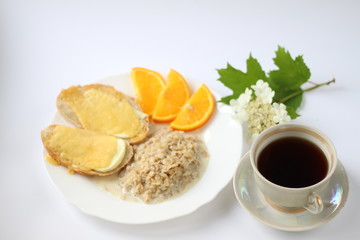 breakfast consists of oatmeal cheese sandwiches and orange slices and a cup of coffee