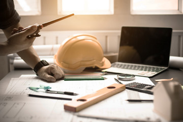 Concept Agreement between the employer and architect Nick and desk of Architectural project in construction site or office building with mining light