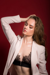 portrait of a young sexy woman on red background