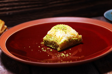 Middle eastern or arabic dishes. Turkish Dessert Baklava with pistachio on dishes