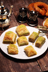 Middle eastern or arabic dishes. Turkish Dessert Baklava with pistachio on dishes