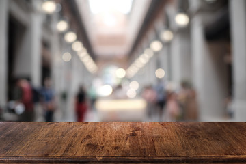 Empty dark wooden table in front of abstract blurred bokeh background of restaurant . can be used for display or montage your products.Mock up for space.
