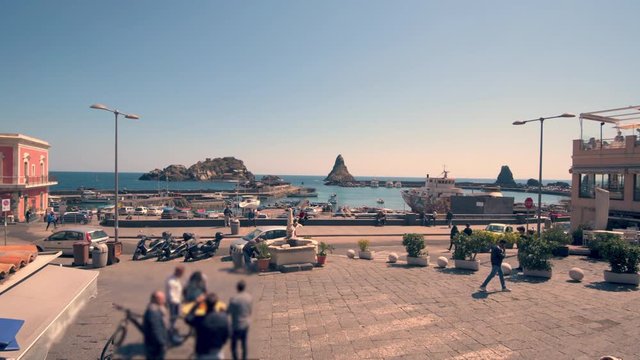 The fishing village of Acitrezza in Sicily with the famous faraglioni (volcanic rock formations)