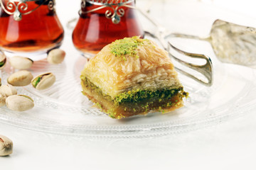 Middle eastern or arabic dishes. Turkish Dessert Baklava with pistachio on dishes