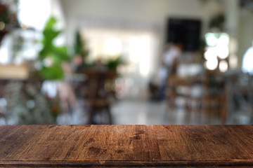 Empty dark wooden table in front of abstract blurred bokeh background of restaurant . can be used for display or montage your products.Mock up for space.