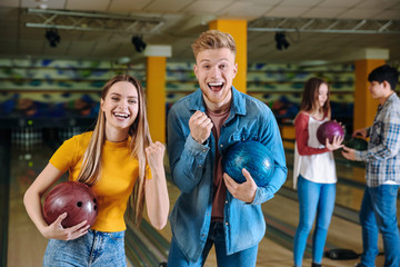 Fototapeta na wymiar Happy friends in bowling club