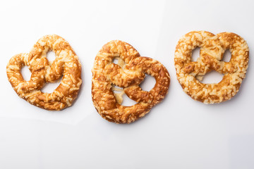 Bread, Pretzels baked with yellow cheese on a white background,