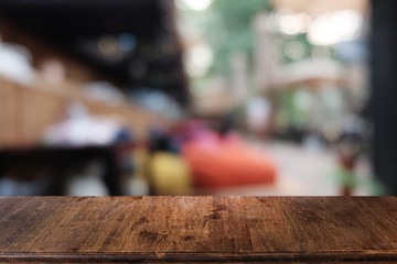 Empty dark wooden table in front of abstract blurred bokeh background of restaurant . can be used for display or montage your products.Mock up for space.