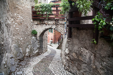 Small town narrow street view with colorful houses in Malcesine