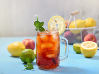 Iced tea with lemons, limes and mint with ice cubes, summer refreshment drink