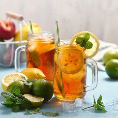 Iced tea with lemons, limes and mint with ice cubes, summer refreshment drink, square image