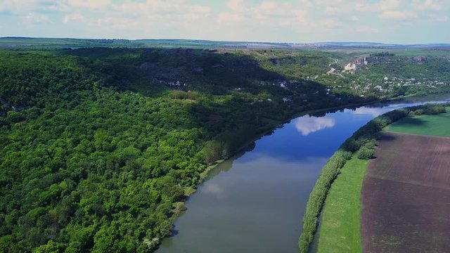 Flight over the river and forest at spring time. Dniester river of Moldova republic.