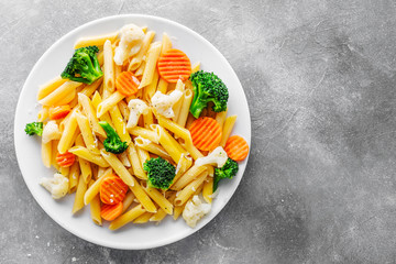 Healthy pasta penne with vegetables on plate