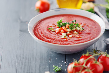 Tasty summer tomato soup served in bowl