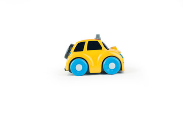 Yellow toy taxi car on a white background