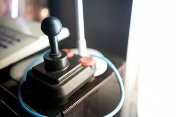 Close up on a joystick with a blurred background in an arcade hall