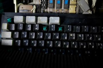 A close view of some keys on a dirty, yellowed keyboard. close up enter button