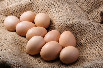 Fresh eggs of a farm on burlap close up. Healthy food, natural protein.