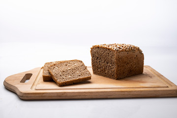 Fototapeta na wymiar Traditional rye sourdough bread. Rye bread on a wooden board on a white background.