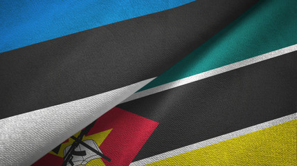 Obraz premium Estonia and Mozambique two flags textile cloth, fabric texture