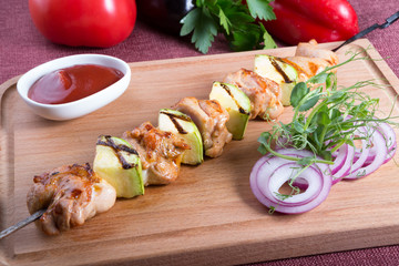 Grilled meat with zucchini on a metal skewer