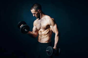 Fototapeta na wymiar Strong sport sirtless man making weightlifting with dumbbells