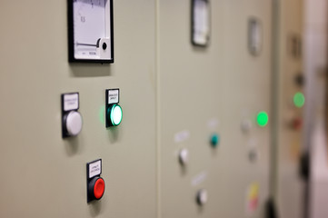 Indicator lights on switchgear door in substation.