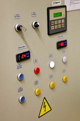 Indicator lights on switchgear door in substation.