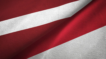 Fototapeta na wymiar Latvia and Indonesia two flags textile cloth, fabric texture