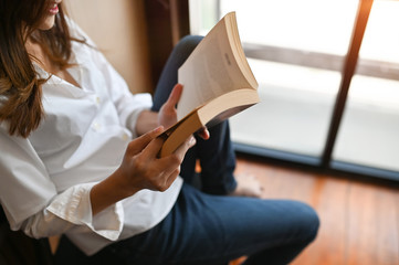 Cropped shot female reading a books.