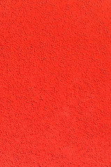 The various facing of the front wall of the house is red.