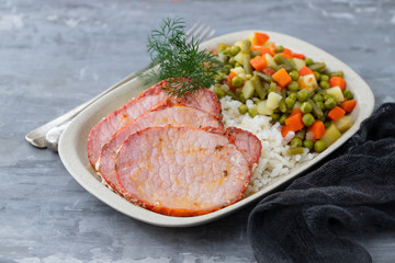 fried pork with boiled rice and vegetables on dish